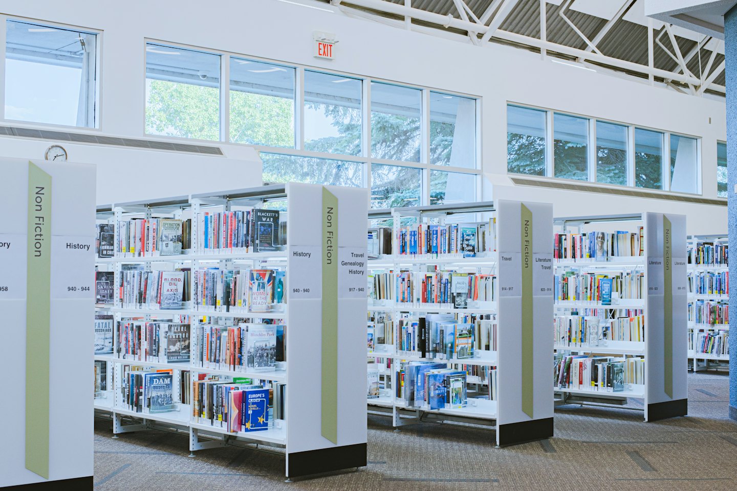 Rows of bookshelves filled with books in a modern library.